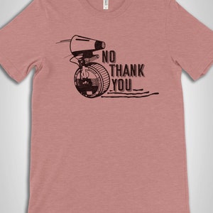 May include: A heather pink t-shirt with a black graphic of a droid from Star Wars with the text "NO THANK YOU".