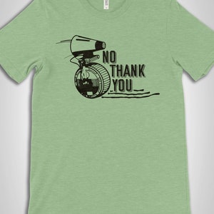 May include: A light green t-shirt with a black and white graphic of a character from Star Wars. The graphic includes the text "No Thank You".