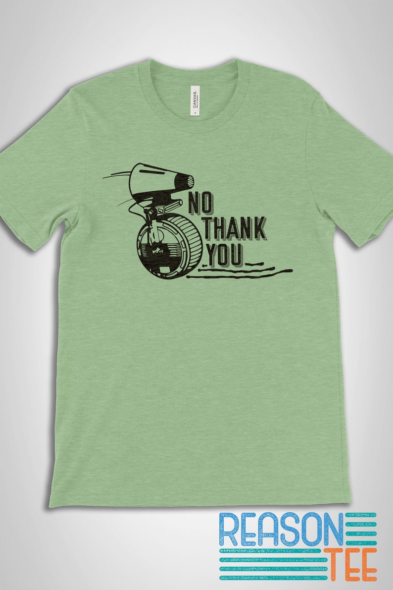 May include: A light green t-shirt with a black and white graphic of a character from Star Wars. The graphic includes the text "No Thank You".
