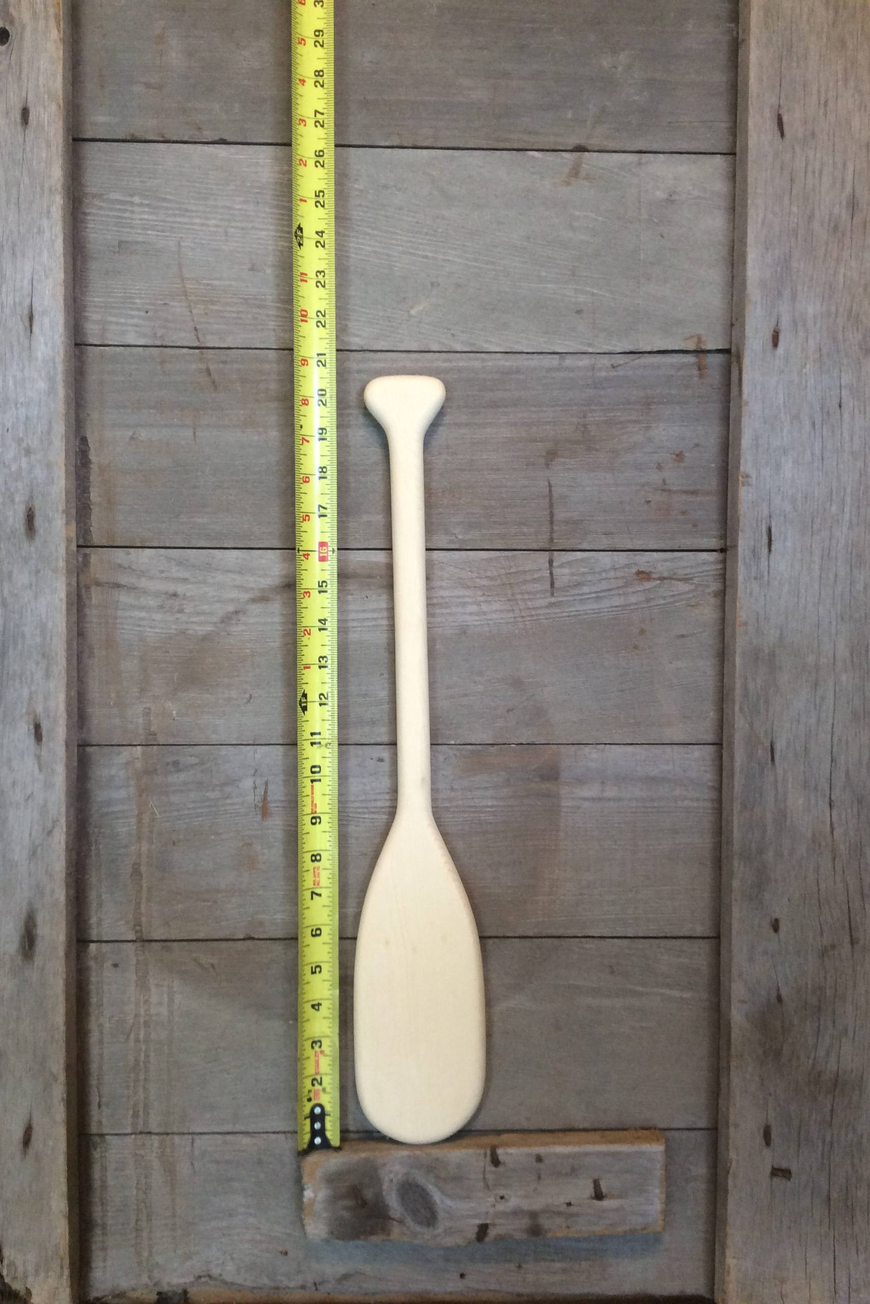 21 inch long unpainted miniature wooden canoe paddle.