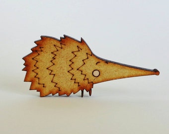 May include: A wooden cutout of a brown hedgehog with a smiling face. The hedgehog has a long snout and a spiky back.