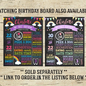 May include: Two black chalkboard signs with rainbow accents, each with the name Charlotte and the text "My First Birthday". The signs list the child's age in inches and pounds, along with other milestones like favorite foods and activities. The signs are decorated with colorful stars, hearts, and rainbows.