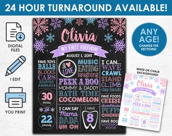 May include: A chalkboard-style first birthday sign with the name "Olivia" in pink and purple. The sign includes the text "My First Birthday" and details like favorite toys, foods, and measurements of 30 inches and 22 pounds.