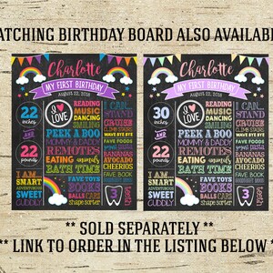 May include: Two black chalkboard style signs with rainbow accents, each with the name Charlotte and the text "My First Birthday". The signs list the child's age in inches and pounds, along with other details like favorite foods and activities. The signs are decorated with rainbows, stars, and hearts.