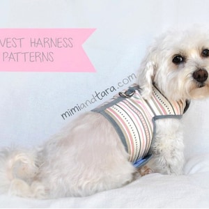 May include: A white dog wearing a striped vest harness with a gray trim. The harness has a metal ring for attaching a leash. The dog is sitting on a white surface. The text "DOG VEST HARNESS PATTERNS" is on a pink banner above the dog. The text "mimiandetara.com" is below the dog.