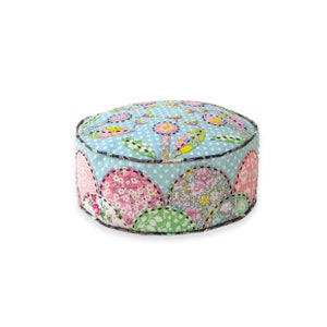 May include: A round, blue and white floral patterned floor cushion with a scalloped edge. The cushion is made of fabric and has a soft, comfortable texture.