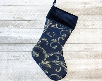 Navy blue Christmas stocking with gold swirls and velvet cuff
