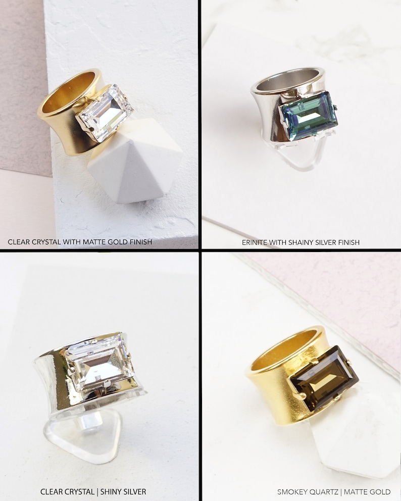 May include: A collection of four rings featuring rectangular crystals in clear, erinite, and smokey quartz colors. The bands are finished in matte gold, shiny silver, or shiny gold. Text labels include Clear Crystal with Matte Gold Finish, Erinite with Shainy Silver Finish, Clear Crystal | Shiny Silver, and Smokey Quartz | Matte Gold.
