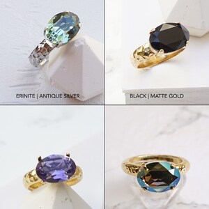May include: Four rings with oval-cut faceted stones. Top left: Erinite stone in an antique silver hammered band. Top right: Black stone in a matte gold hammered band. Bottom left: Tanzanite stone in a matte gold band. Bottom right: Bronze shade stone in a matte gold band.