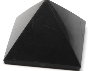 May include: A black obsidian pyramid crystal. The pyramid is smooth and polished with a dark, reflective surface.