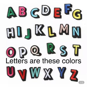May include: Colorful felt alphabet letters in uppercase. The letters are A through Z and are in various colors, including red, blue, green, yellow, pink, and white. The text "Letters are these colors" is below the letters.