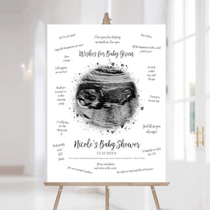 Puede incluir: Una imagen de ultrasonido en blanco y negro de un bebé está rodeada de salpicaduras de acuarela grises. El texto "Wishes for Baby Green" está en la parte superior de la imagen. El texto "Nicole's Baby Shower 12.10.20XX" está en la parte inferior de la imagen. La imagen está sobre un fondo blanco.