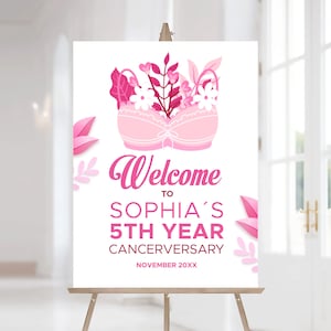 Puede incluir: Un cartel de bienvenida rosa con un sujetador decorado con flores y hojas rosas. El cartel dice "Bienvenido a Sophia's 5th Year Cancerversary November 20XX".