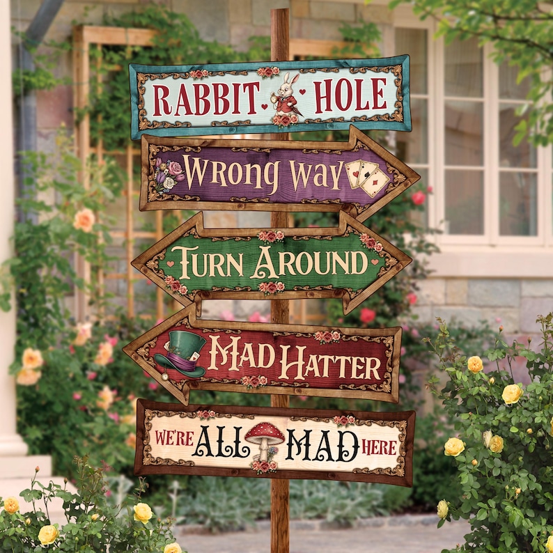 May include: A whimsical wooden signpost with five directional signs, each with text from Alice in Wonderland. The signs are in various colors, including teal, purple, green, and red, with floral and decorative accents. The top sign reads "Rabbit Hole."
