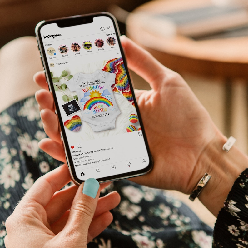 May include: A smartphone displaying an Instagram post with a photo of a white onesie with a rainbow and the text "After the storm comes peace, memories & a beautiful rainbow. Baby Jackson December 2022".
