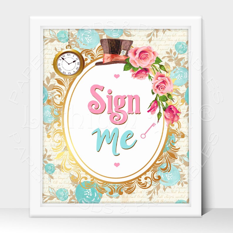May include: A white framed sign with a gold oval border and a white background. The sign says "Sign Me" in pink and blue lettering. The oval border is decorated with a floral pattern of pink roses and blue flowers. A top hat with a red and white ribbon is at the top of the sign.
