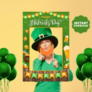Puede incluir: Atrezzo para cabina de fotos verde y naranja con un sombrero de duende, barba y el texto "Happy St. Patrick's Day" y "Lucky".