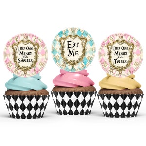 May include: Three cupcakes with different colored frosting and topped with round edible paper decorations. The decorations feature a clock face with the text "This One Makes You Smaller", "Eat Me", and "This One Makes You Taller".
