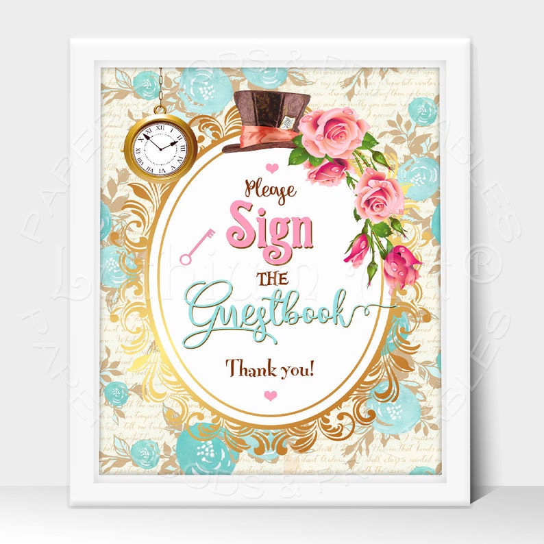 May include: A white frame with a gold ornate oval sign that says "Please Sign the Guestbook Thank you!" with a pink heart. The sign is surrounded by pink and white roses, a blue pocket watch, and a blue and brown top hat.