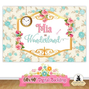 May include: A digital backdrop featuring a gold frame with the text "Mia in Wonderland" in pink and blue lettering. The frame is decorated with pink roses and a gold key. A gold pocket watch with Roman numerals hangs from the top of the frame. The background is a cream color with a pattern of blue flowers.