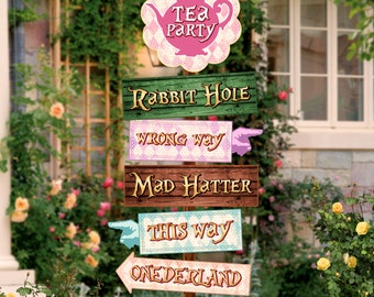 May include: A set of wooden signs with whimsical text and arrows, perfect for a Mad Hatter themed party. The signs read "Tea Party", "Rabbit Hole", "Wrong Way", "Mad Hatter", "This Way", and "Wonderland".