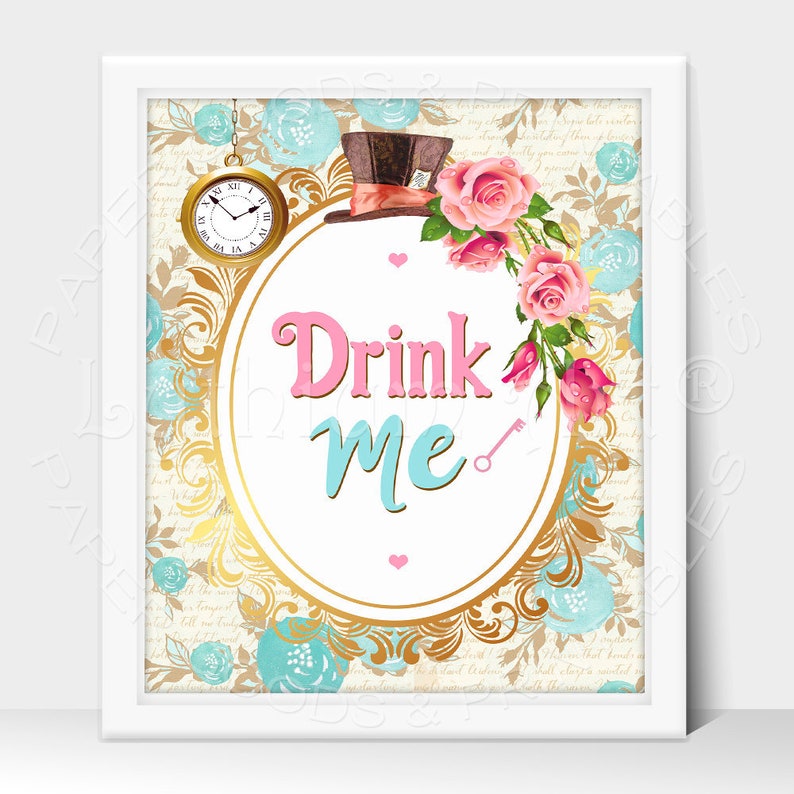 May include: A white oval frame with a gold border and a pink and blue "Drink Me" sign inside. The frame is decorated with a gold pattern and blue and pink flowers. A top hat and a pocket watch are in the background.