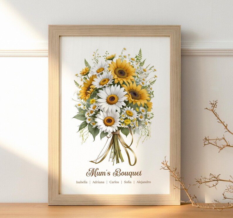 May include: A framed print featuring a watercolor bouquet of sunflowers and daisies. The flowers are tied with a ribbon. The text "Mum's Bouquet" is below the flowers, with names beneath it. The frame is light brown.