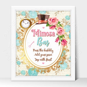 May include: A white framed sign with a gold and blue floral design. The sign says "Mimosa Bar" in pink and blue lettering. The text below says "Pour the bubbly, Add some juice, Top with fruit".