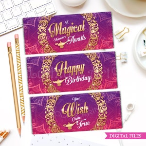 May include: Three printable chocolate bar wrappers with a purple and pink background and gold accents. The wrappers feature a genie lamp and the text "A Magical Adventure Awaits", "Happy Birthday", and "Your Wish Came True".