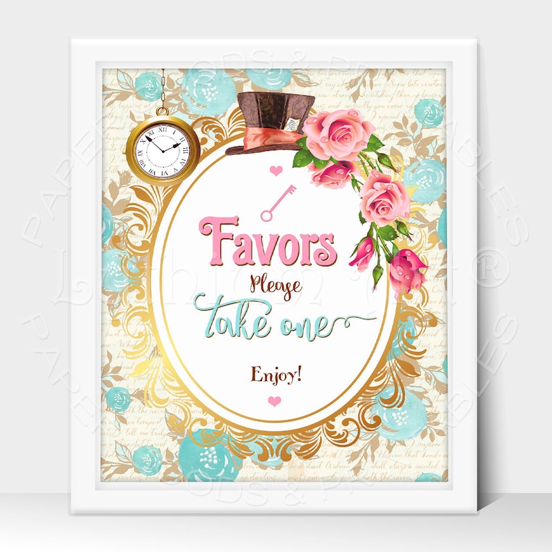 May include: A white framed sign with a gold ornate oval border and a whimsical Alice in Wonderland theme. The sign features a pink and white floral design, a Mad Hatter's hat, a pocket watch, and the text "Favors Please Take One Enjoy!"