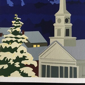 May include: A snowy night scene with a white church steeple and a snow-covered evergreen tree in the foreground. The church is illuminated by a bright yellow moon in the sky. The mountains in the background are a dark blue colour.