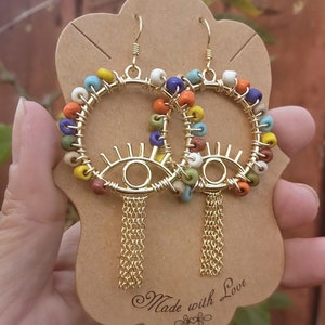 Beaded Evil eye hoop earrings, artisan earrings,wirewrapped African seed beads,rainbow earrings