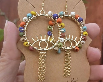 Beaded Evil eye hoop earrings, artisan earrings,wirewrapped African seed beads,rainbow earrings