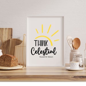 May include: A white framed print with a yellow sun graphic and the text "Think Celestial" in black with the name "Russell M. Nelson" in smaller font below.