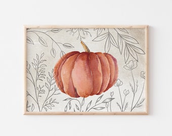 May include: Watercolor painting of a pumpkin in shades of orange and pink, set against a beige background with sketched floral and leaf outlines. The artwork is framed in a light wood.