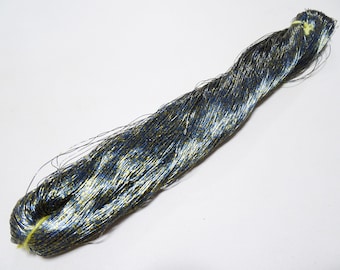 May include: A spool of blue and gold metallic thread. The thread is very fine and has a shimmery finish.