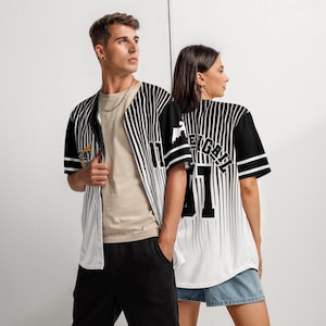 May include: Two baseball jerseys with black and white vertical stripes. One jersey has the number "01" and the text "EY GATL" on the back. The other jersey has a small graphic on the left side of the chest.