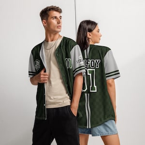 May include: Green and gray baseball jersey with a checkered pattern and the text "SEER" and "MALFOY" on the back. The jersey has a white number "01" on the front and back.