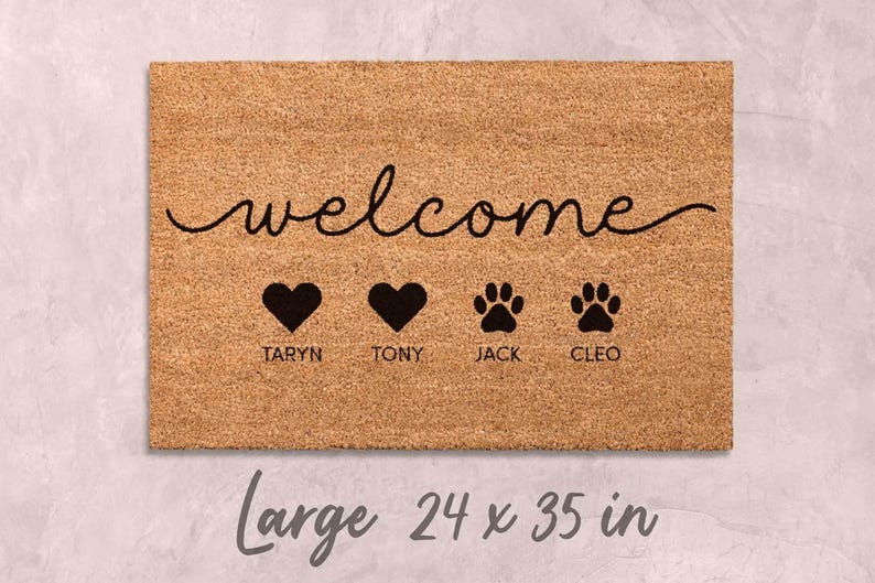 A welcome mat with the word "welcome" written on it, along with three heart symbols and the names "TARYN", "TONY", and "JACK" below them.