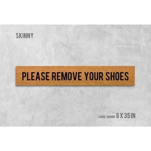 a sign that reads "Please remove your shoes" in bold black letters.