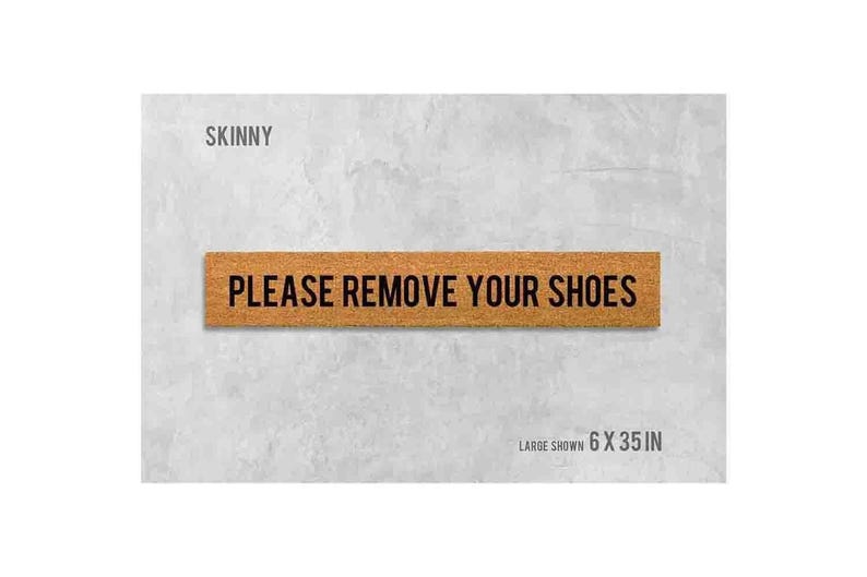 a sign that reads "Please remove your shoes" in bold black letters.