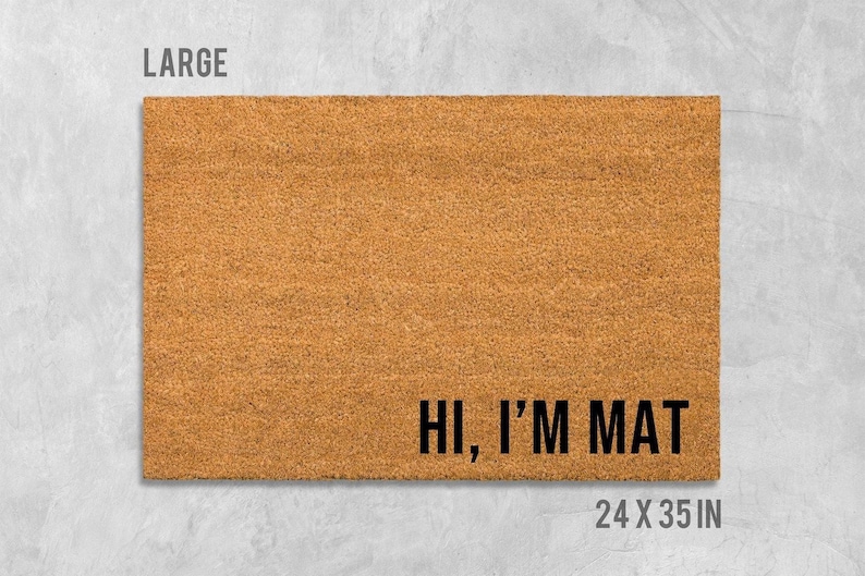 A large rectangular welcome mat with the text "HI, I'M MAT" printed on it.