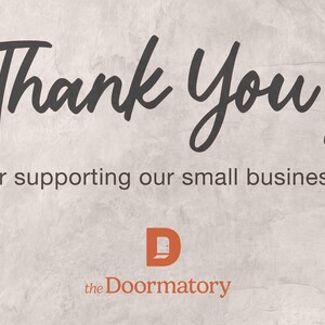 a message that reads "Thank You! for supporting our small business!" The text is written in a casual, handwritten style. The image also features the logo of a company called "the Doormatory".