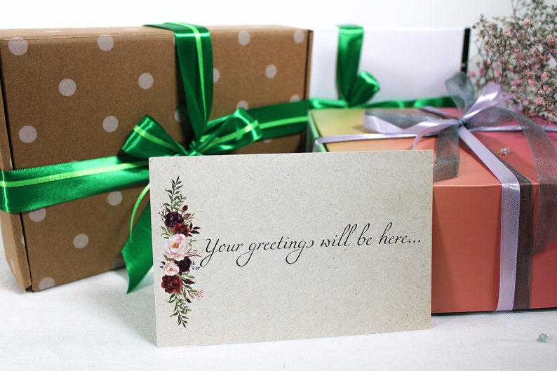 May include: A card with a floral design and the text "Your greetings will be here..." on a brown background. The card is in front of three wrapped gifts with green, purple, and brown ribbon.