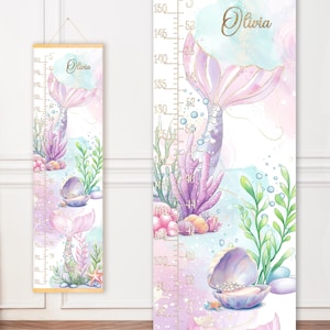 May include: A mermaid-themed growth chart with a watercolor design. The chart features a mermaid tail, seashells, and aquatic plants in shades of pink, purple, and green. The chart measures up to 5 feet (152 cm) and includes the name "Olivia".