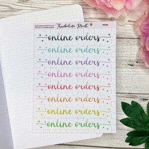 May include: A sheet of rainbow colored stickers with the text "online orders" repeated eight times. The stickers are on a white background with a grid pattern.