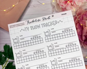 May include: A white TV show tracker sheet with the text "TV SHOW TRACKER" and the seller's name. The sheet includes spaces to track shows, seasons, and reviews. The sheet is decorated with stars and TV graphics.