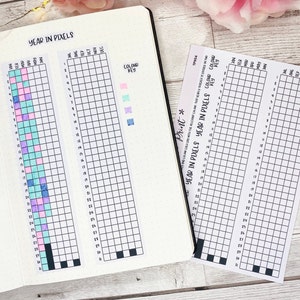May include: Two printable year in pixels trackers with a color key. The trackers are divided into 31 squares for each month of the year. The color key shows four colors: pink, light blue, turquoise, and purple.