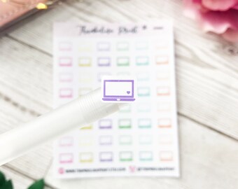 May include: A sheet of purple and white laptop stickers. The stickers are arranged in a grid pattern on a white sheet of paper. The stickers are all the same size and shape, and they feature a simple outline of a laptop with a small heart in the top right corner.