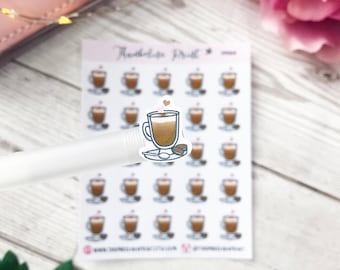 Peut inclure: Une feuille de 25 autocollants représentant un latte avec un cœur sur le dessus. Les autocollants sont blancs avec un contour doré et sont disposés en grille. Le texte "Thousand Mile Stroll" est en haut de la feuille.